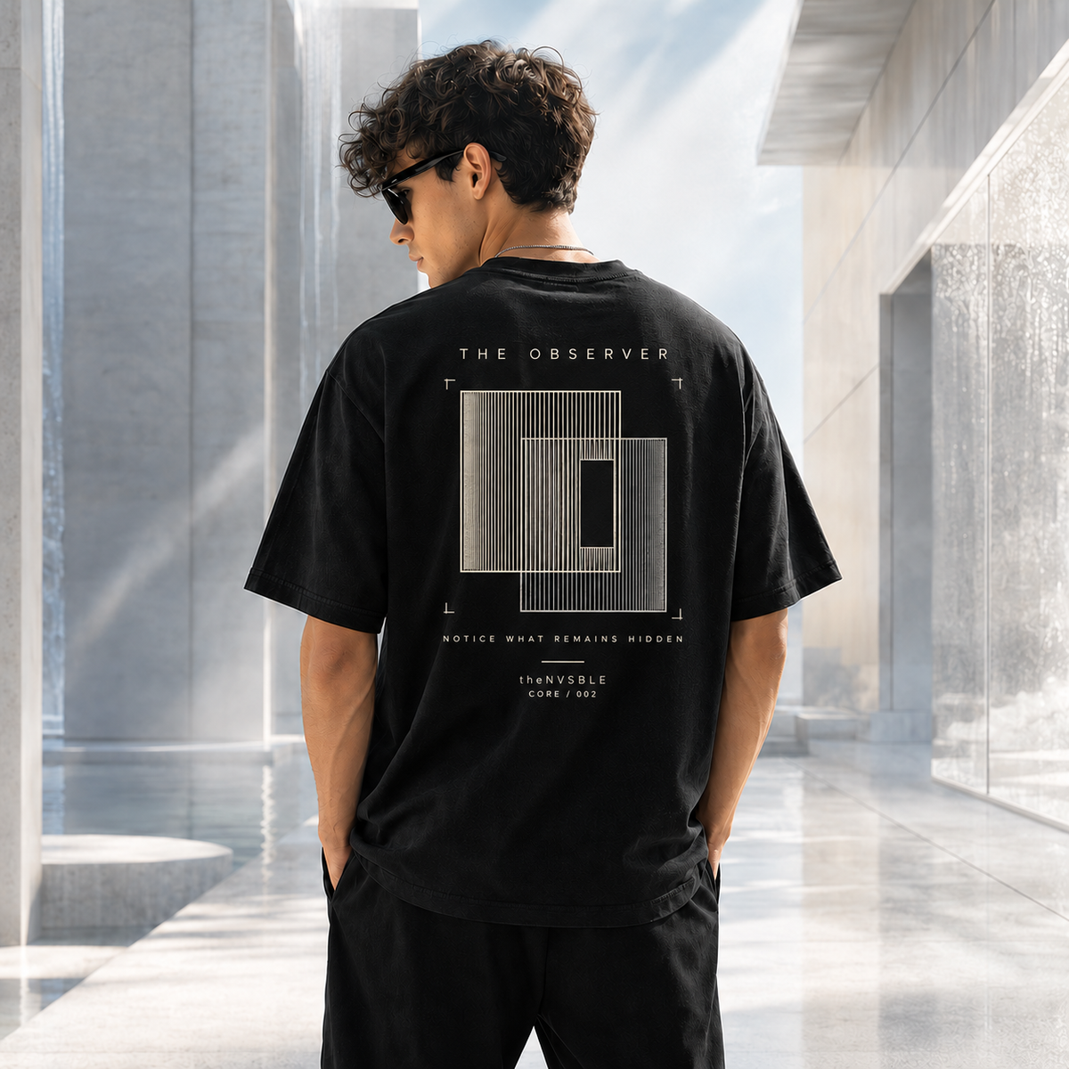 theNVSBLE CORE 002 The Observer black T-shirt, back view with new layered viewfinder artwork