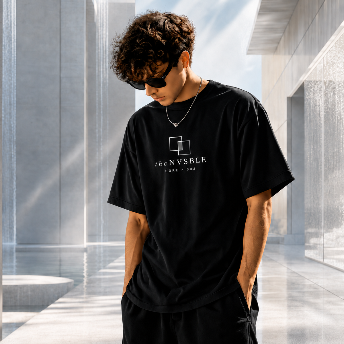 theNVSBLE CORE 002 The Observer black T-shirt, alternate front pose with matching emblem