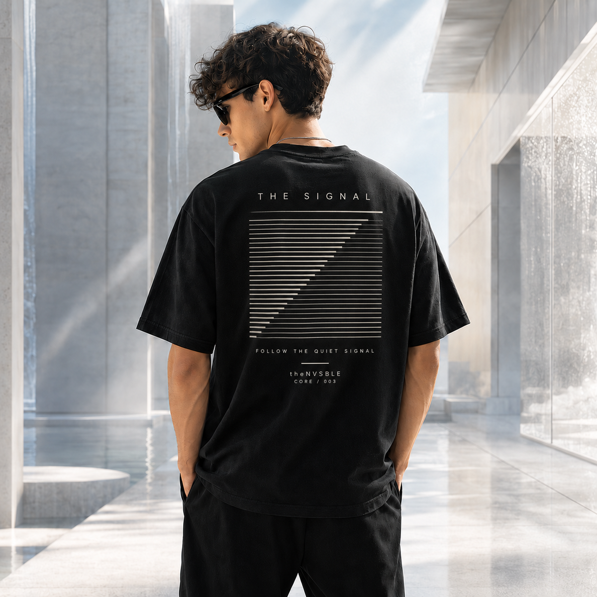 theNVSBLE CORE 003 THE SIGNAL black T-shirt, back view with new linear signal artwork
