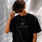 theNVSBLE CORE 004 THE FEW black T-shirt, front view with new geometric emblem