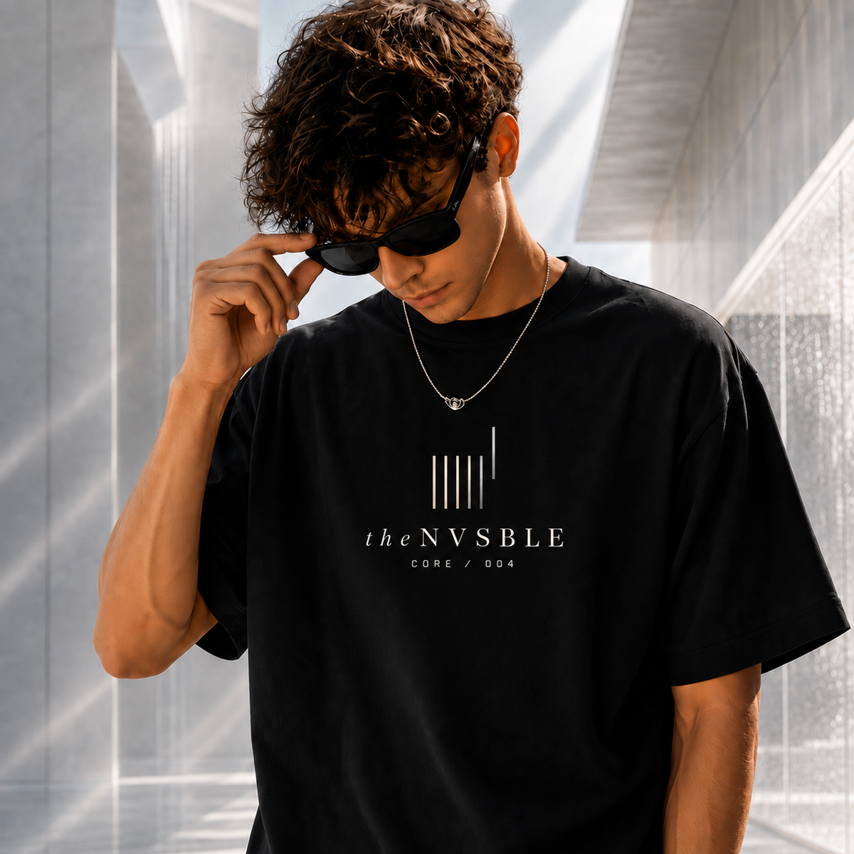 theNVSBLE CORE 004 THE FEW black T-shirt, front view with new geometric emblem