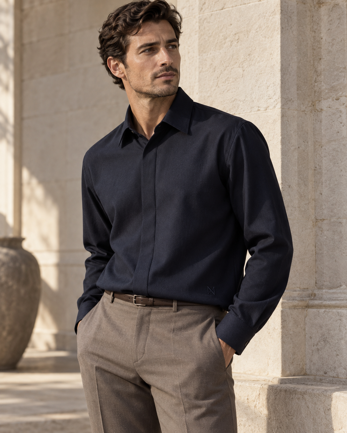 Design preview: midnight navy NIGHTFALL shirt with a concealed-button front, styled with taupe trousers.